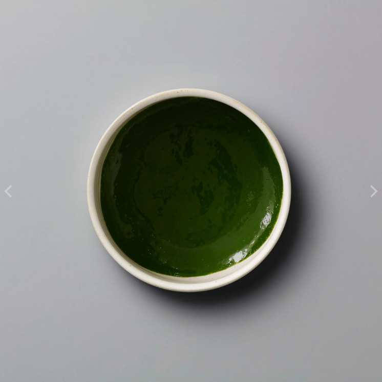 Bright green Matcha Wazuka ceremonial matcha in a minimalist bowl, featuring a smooth texture and rich color on a clean neutral background.